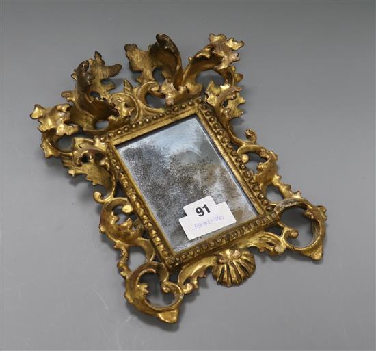 A small Victorian Florentine carved giltwood framed mirror length 31cm